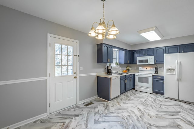 kitchen with white appliances, sink, decorative light fixtures, blue cabinetry, and a notable chandelier