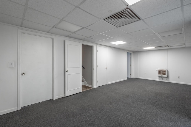 basement with dark colored carpet and heating unit