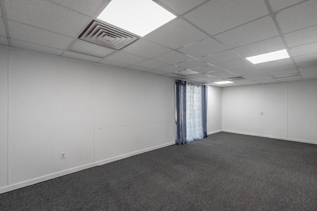 carpeted empty room with a paneled ceiling