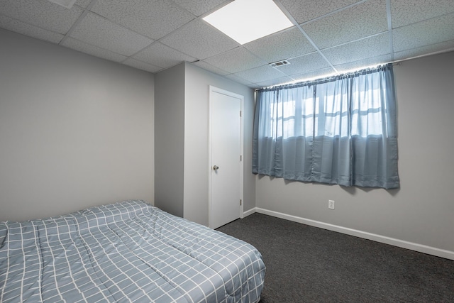 carpeted bedroom featuring a paneled ceiling