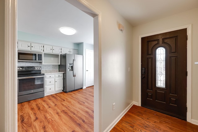 entryway with light hardwood / wood-style flooring