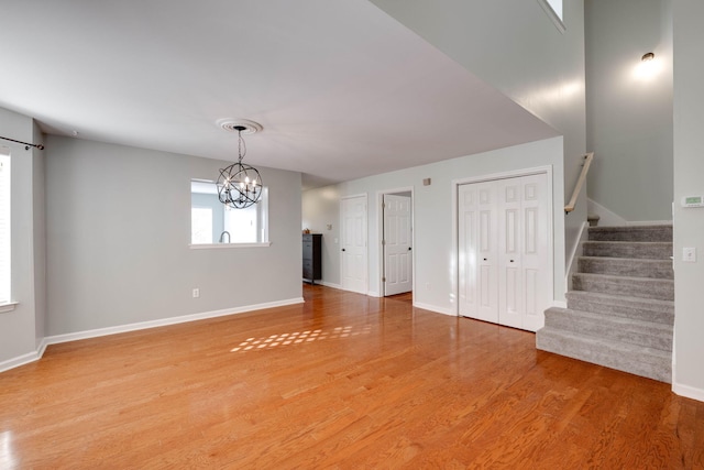 interior space with hardwood / wood-style floors and an inviting chandelier