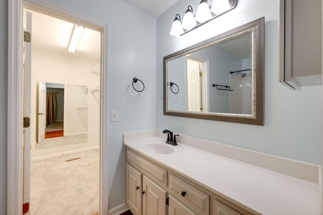 bathroom featuring a shower and vanity