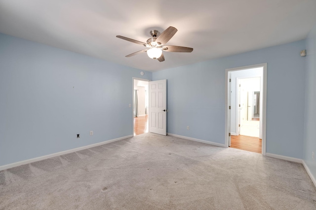 unfurnished bedroom with ceiling fan and light colored carpet