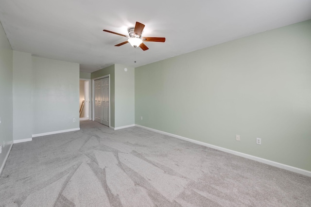 carpeted spare room featuring ceiling fan