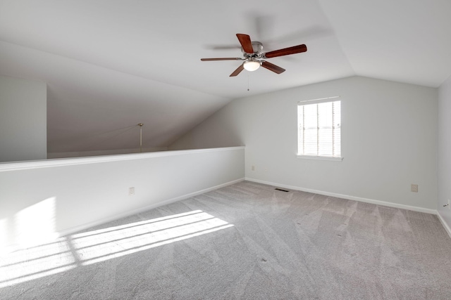 additional living space with carpet flooring, ceiling fan, and lofted ceiling