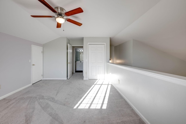 bonus room featuring light colored carpet, ceiling fan, and lofted ceiling