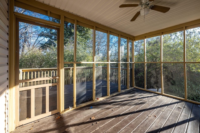 unfurnished sunroom featuring ceiling fan