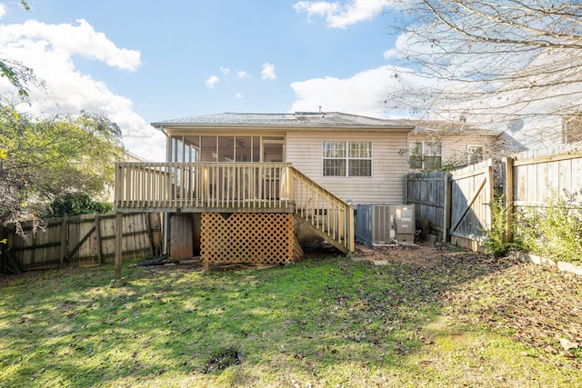 rear view of house with a yard, a sunroom, a deck, and central air condition unit