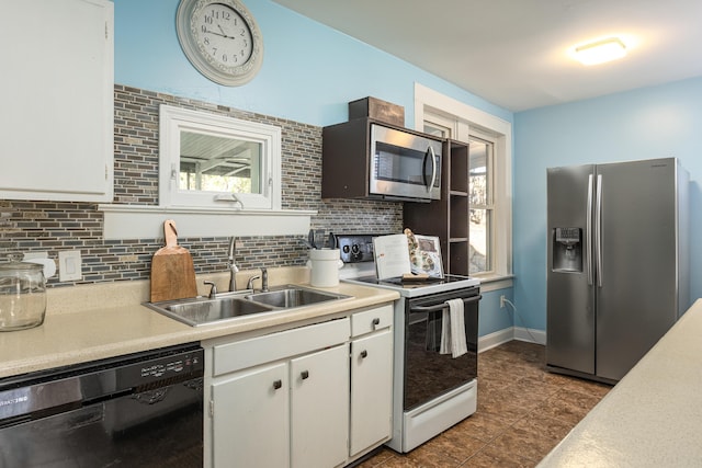 kitchen featuring white cabinets, appliances with stainless steel finishes, backsplash, and sink