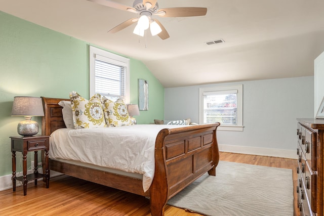 bedroom with light wood-type flooring, ceiling fan, and lofted ceiling