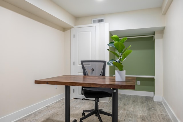 unfurnished office featuring light hardwood / wood-style floors