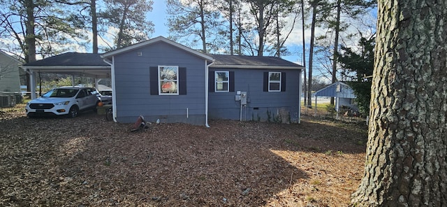 rear view of property with a carport