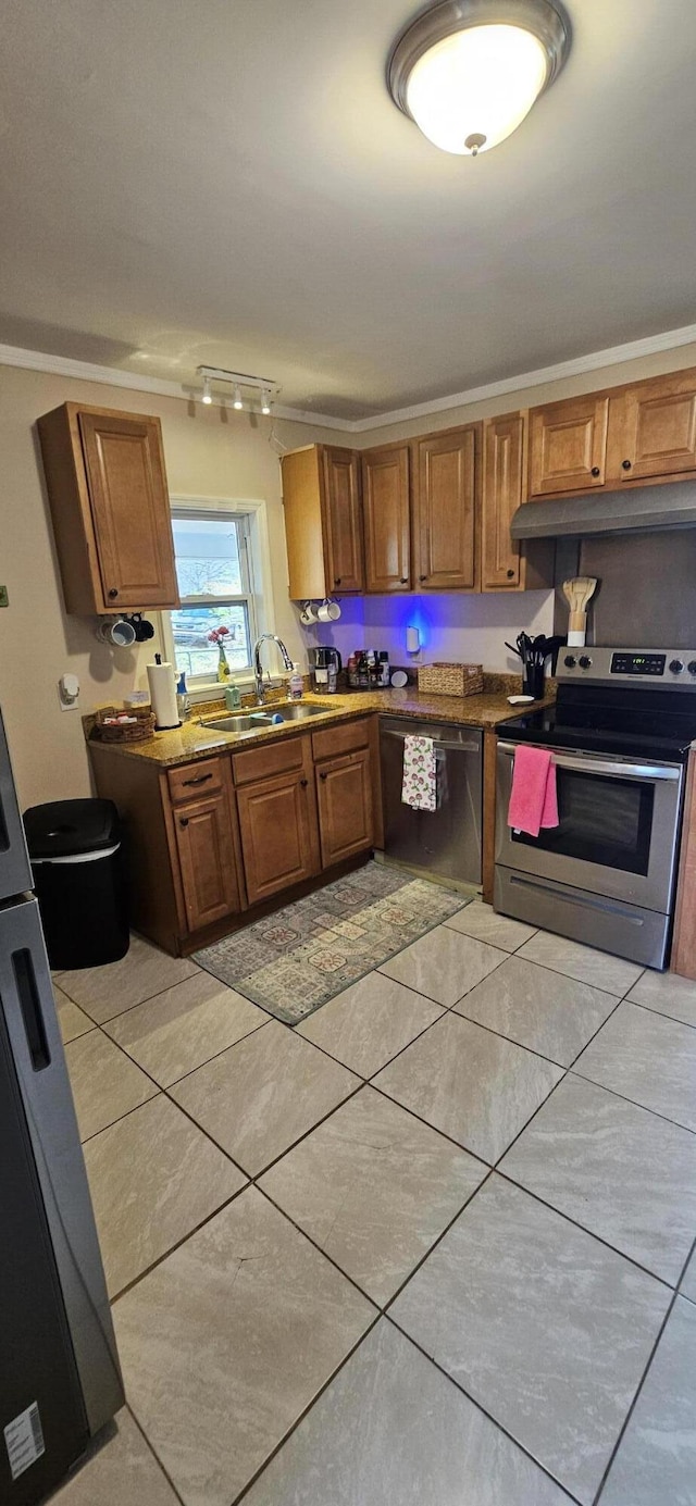 kitchen featuring sink, light tile patterned floors, and stainless steel appliances