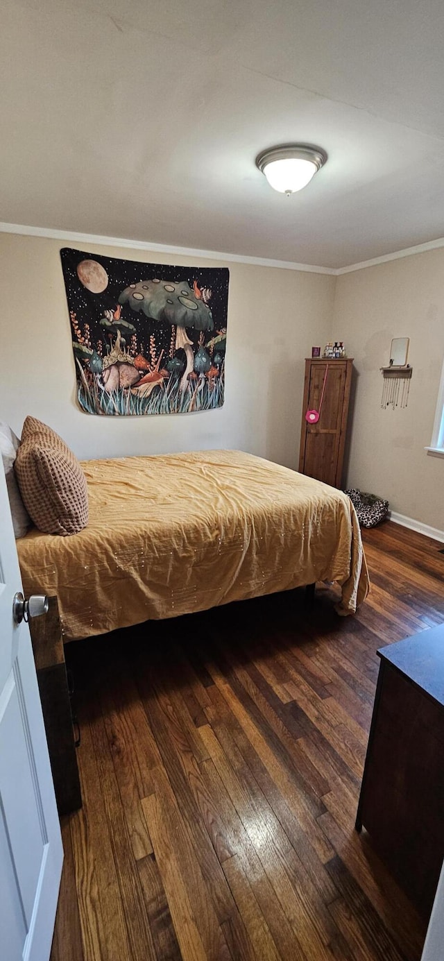 bedroom with dark hardwood / wood-style floors and crown molding