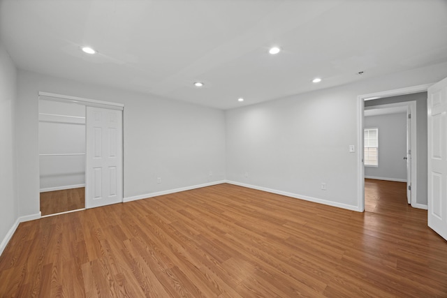 unfurnished bedroom with a closet and light wood-type flooring