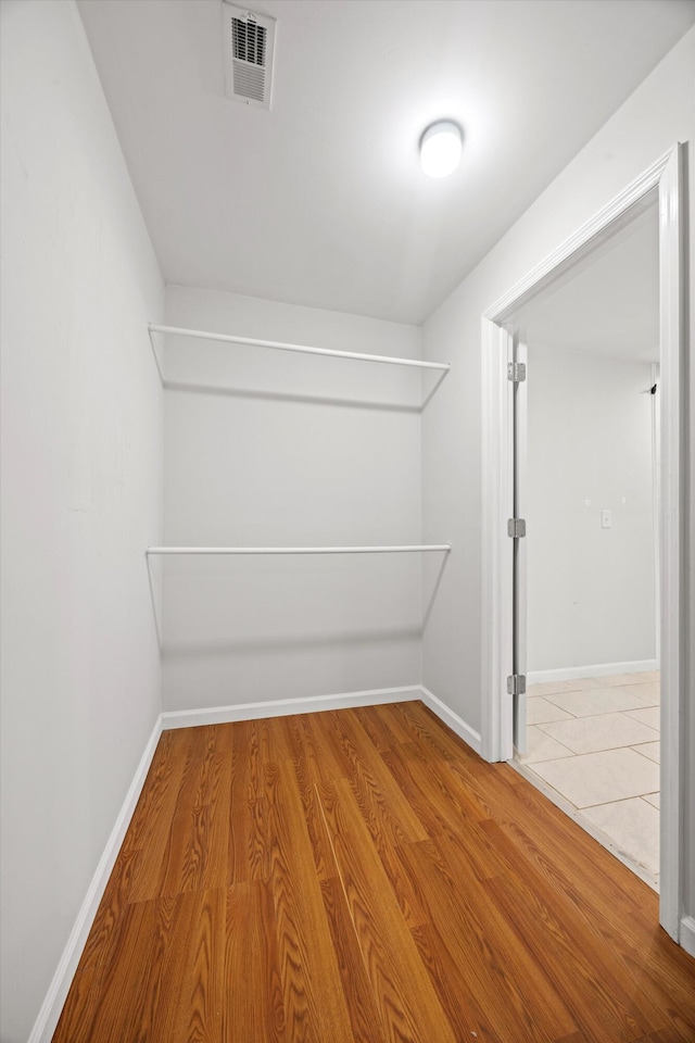 spacious closet featuring hardwood / wood-style floors