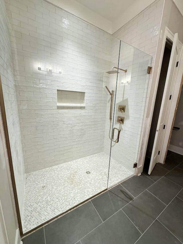 bathroom featuring tile patterned flooring and a shower with door