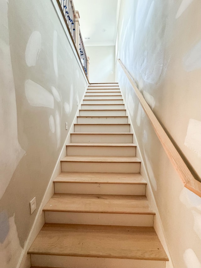 stairs with crown molding