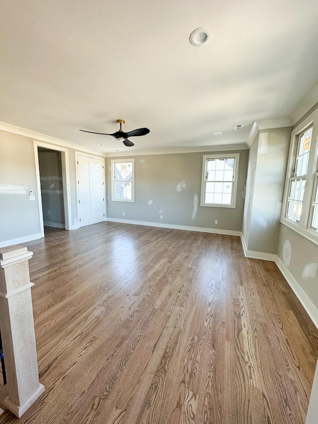 interior space featuring light hardwood / wood-style floors, ceiling fan, and crown molding