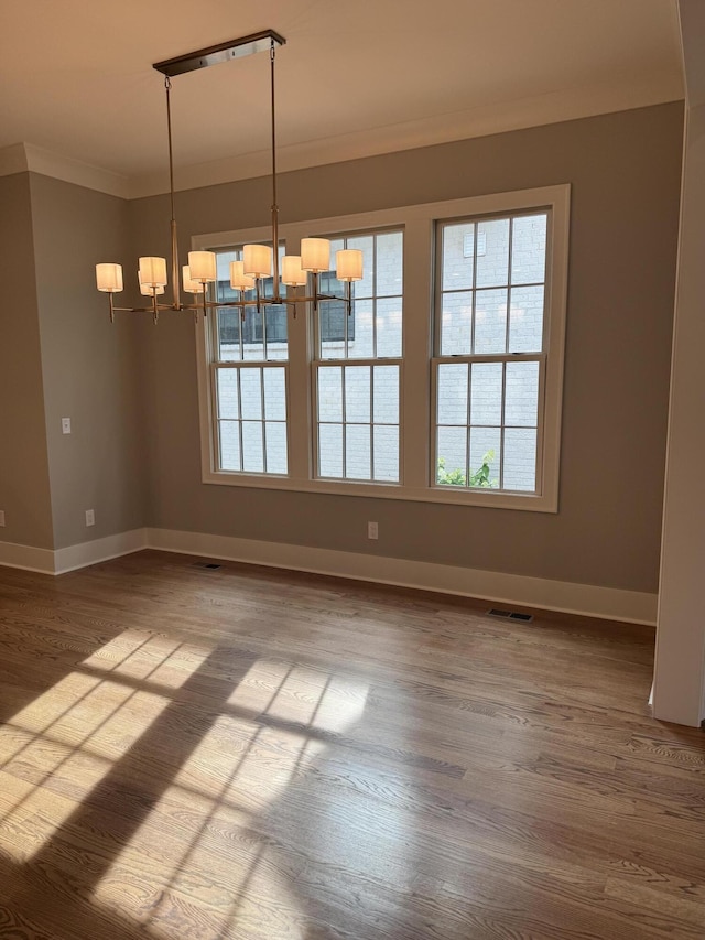 9418 Haviland Way, Ooltewah, TN 37363 - empty room featuring crown molding, a chandelier, and wood finished floors