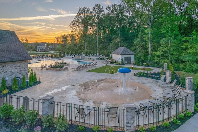9418 Haviland Way, Ooltewah, TN 37363 - pool at dusk featuring a community pool, a patio area, and an outdoor structure