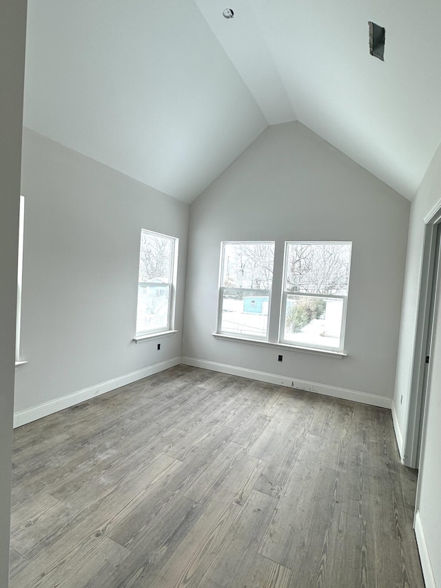 interior space featuring light hardwood / wood-style floors and vaulted ceiling