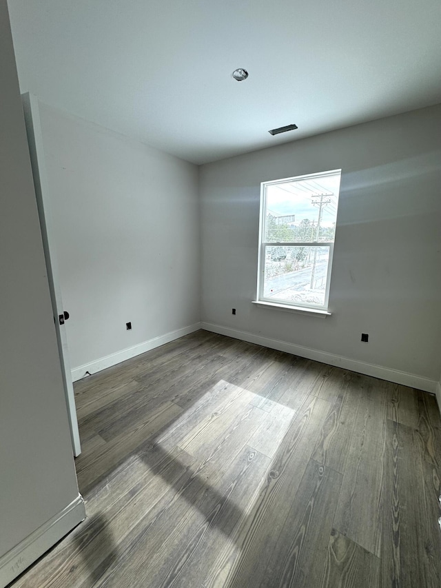 unfurnished room with hardwood / wood-style flooring