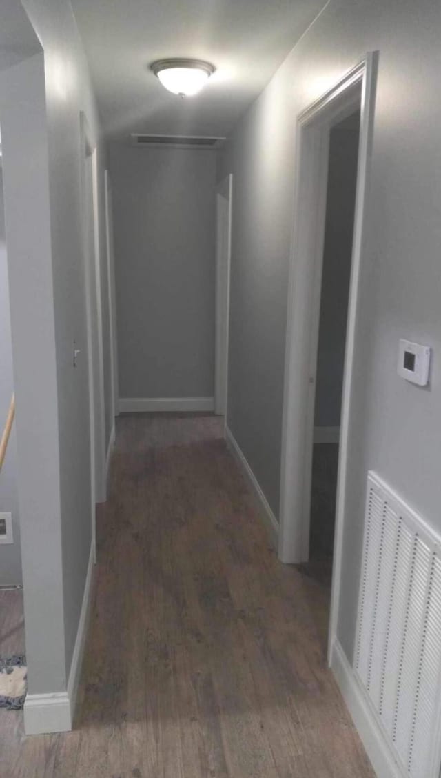 hallway with dark wood-type flooring