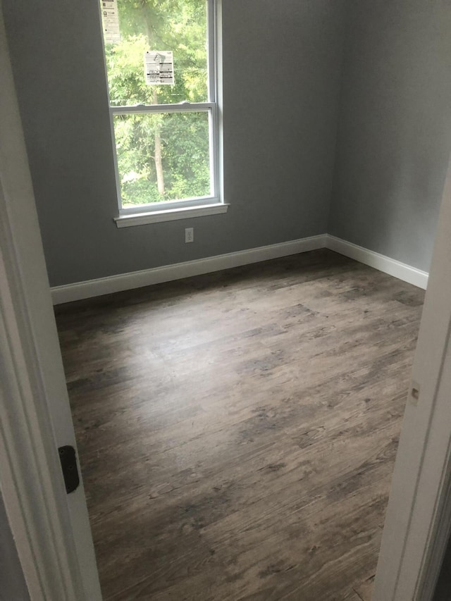 spare room with dark hardwood / wood-style flooring