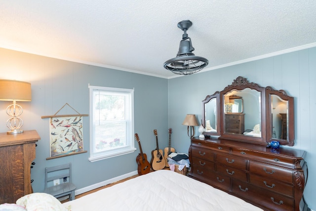 bedroom featuring hardwood / wood-style flooring, ornamental molding, and a textured ceiling