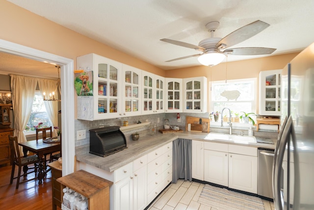 kitchen with white cabinetry, sink, and stainless steel appliances