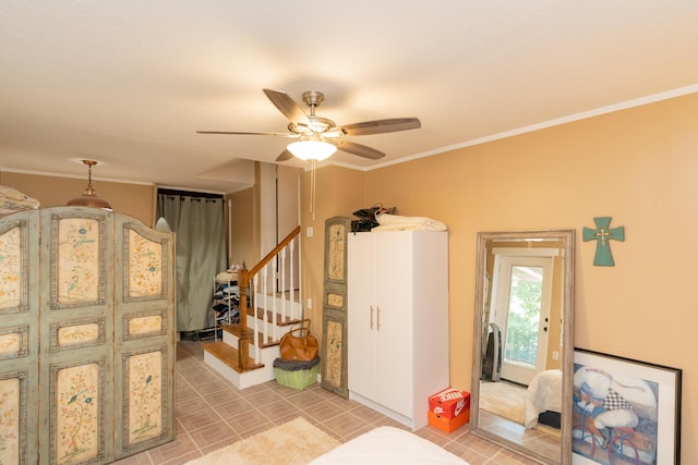 interior space with ceiling fan and ornamental molding