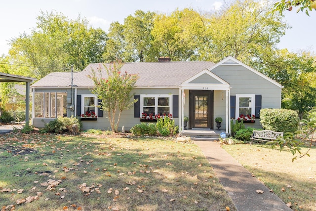 view of front facade featuring a front yard and a sunroom