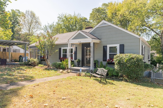 bungalow-style house with fence, a front lawn, and roof with shingles