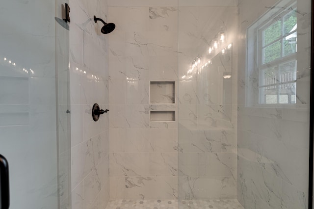 bathroom featuring a shower with door