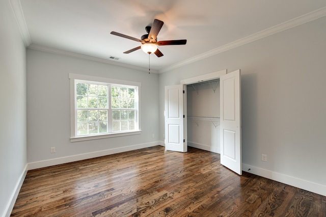 unfurnished bedroom featuring a closet, dark wood-type flooring, ceiling fan, and ornamental molding