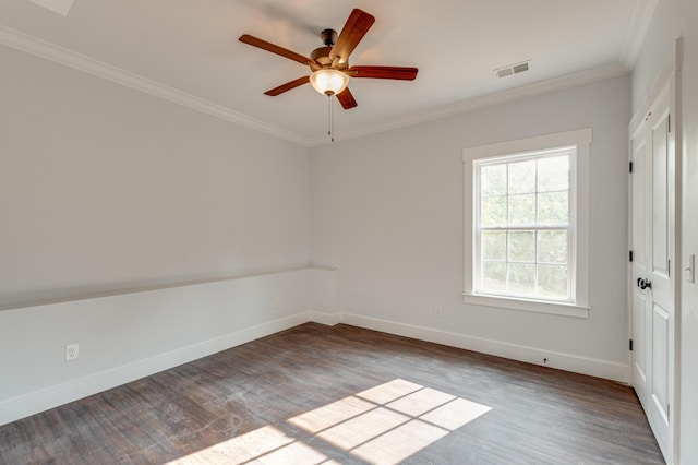 empty room featuring crown molding, hardwood / wood-style floors, and ceiling fan