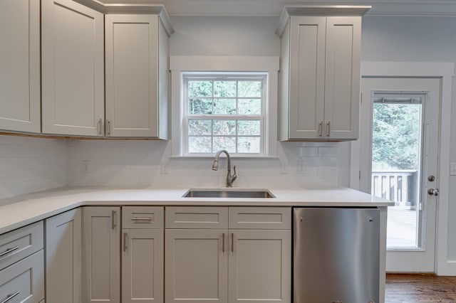 kitchen featuring gray cabinets, sink, and tasteful backsplash