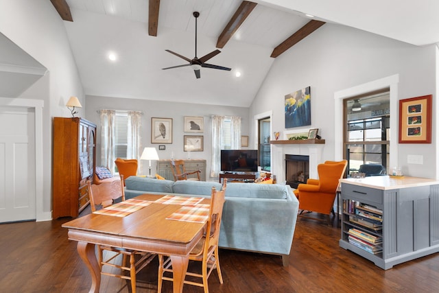 living room featuring beamed ceiling, dark hardwood / wood-style floors, high vaulted ceiling, and ceiling fan