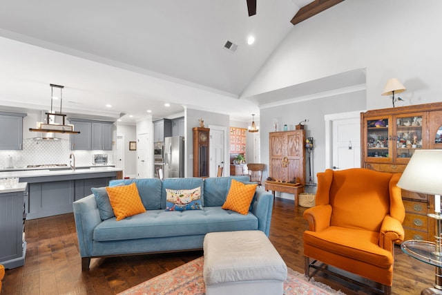 living room with ceiling fan, dark hardwood / wood-style flooring, and high vaulted ceiling