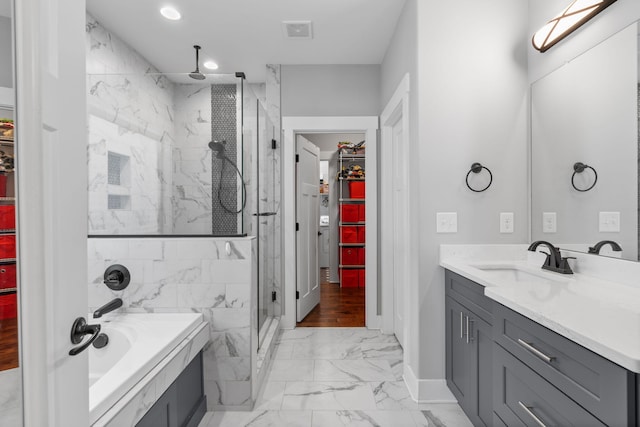 bathroom with vanity and independent shower and bath