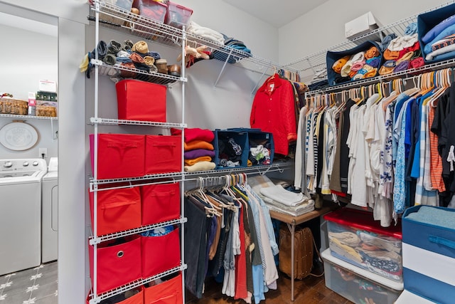 spacious closet with washing machine and clothes dryer and hardwood / wood-style flooring