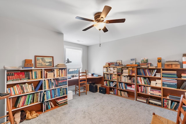 carpeted office featuring ceiling fan