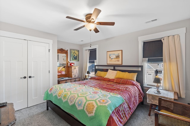 carpeted bedroom with a closet and ceiling fan