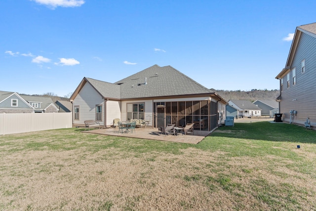 back of house with a patio, a sunroom, and a lawn