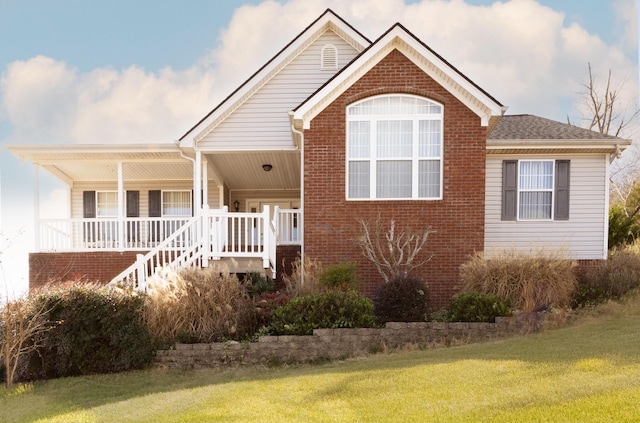 view of front of home with a porch and a front lawn