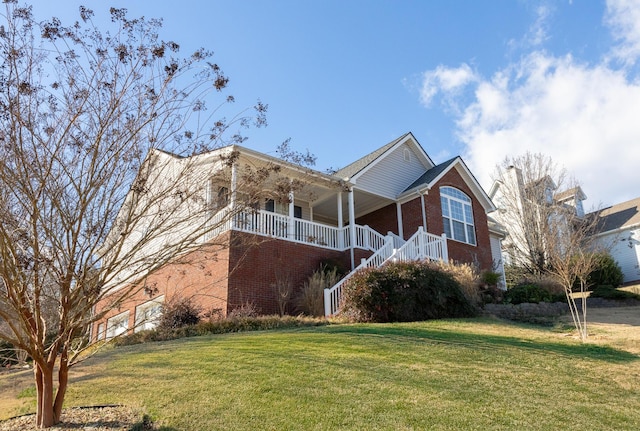 view of front of property with covered porch and a front yard