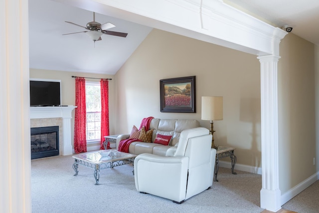 carpeted living room featuring a fireplace, vaulted ceiling, and ceiling fan