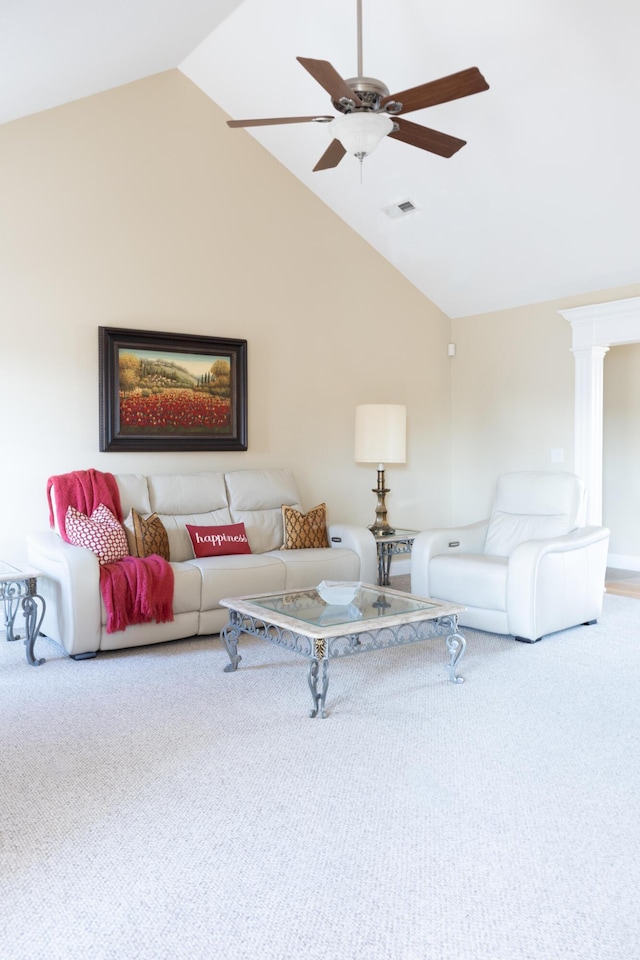 carpeted living room with decorative columns, ceiling fan, and vaulted ceiling